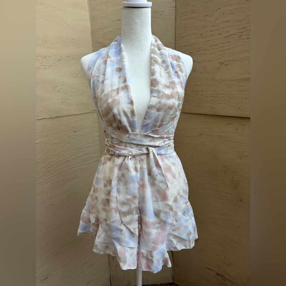 Gorgeous tie dye printed romper with open back ruffled hem.  Brand new!